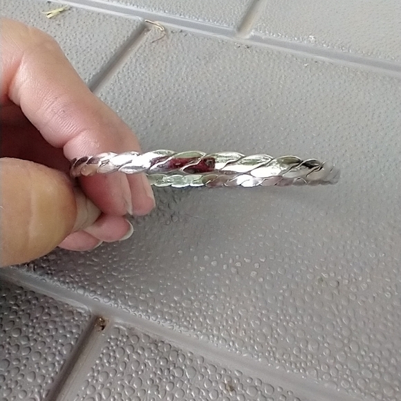 Women's thin silver tone braided bangle bracelet. - Picture 3 of 3